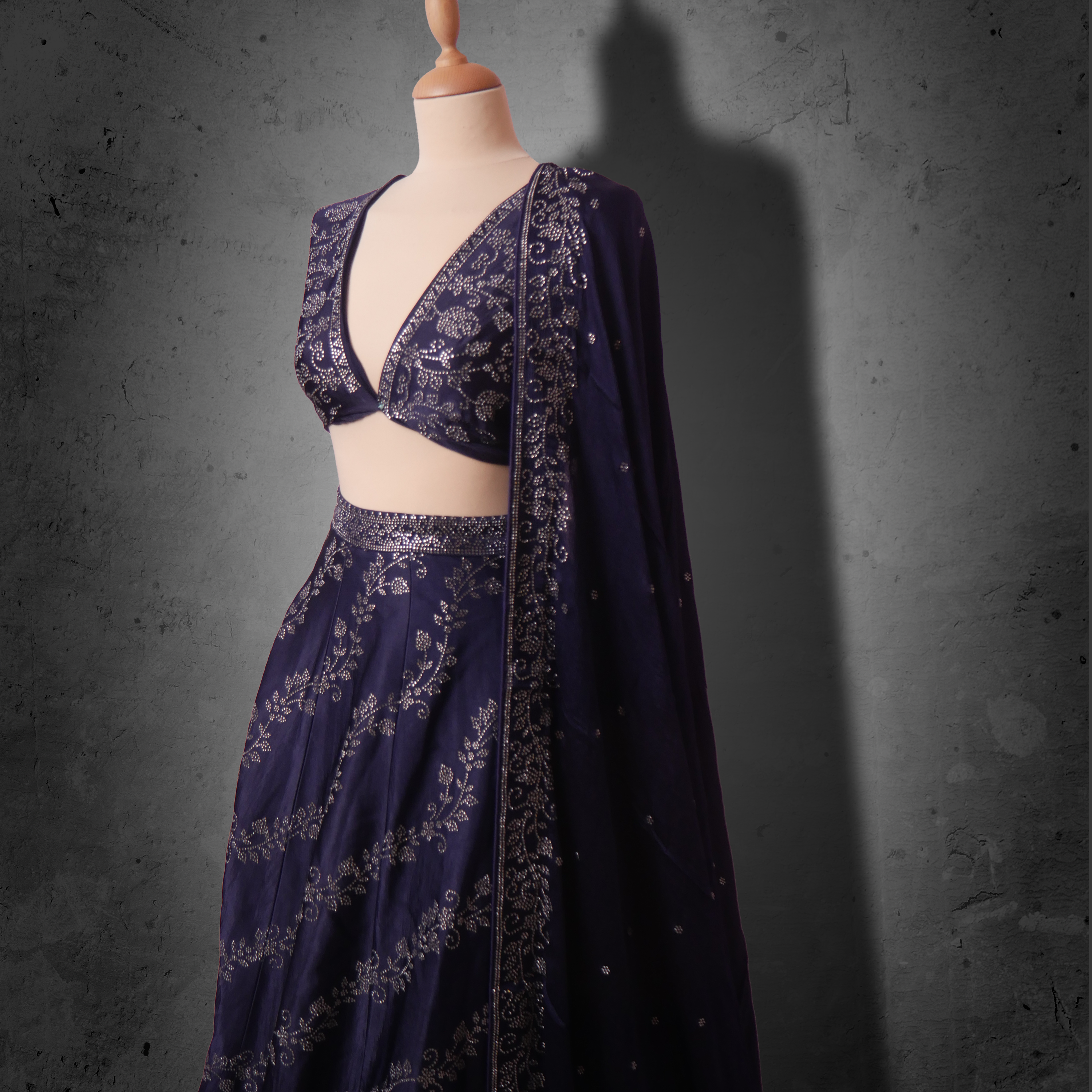 Unstitched navy blue lehenga with tonal sequin embroidery and matching dupatta. Ideal for festive and partywear occasions.