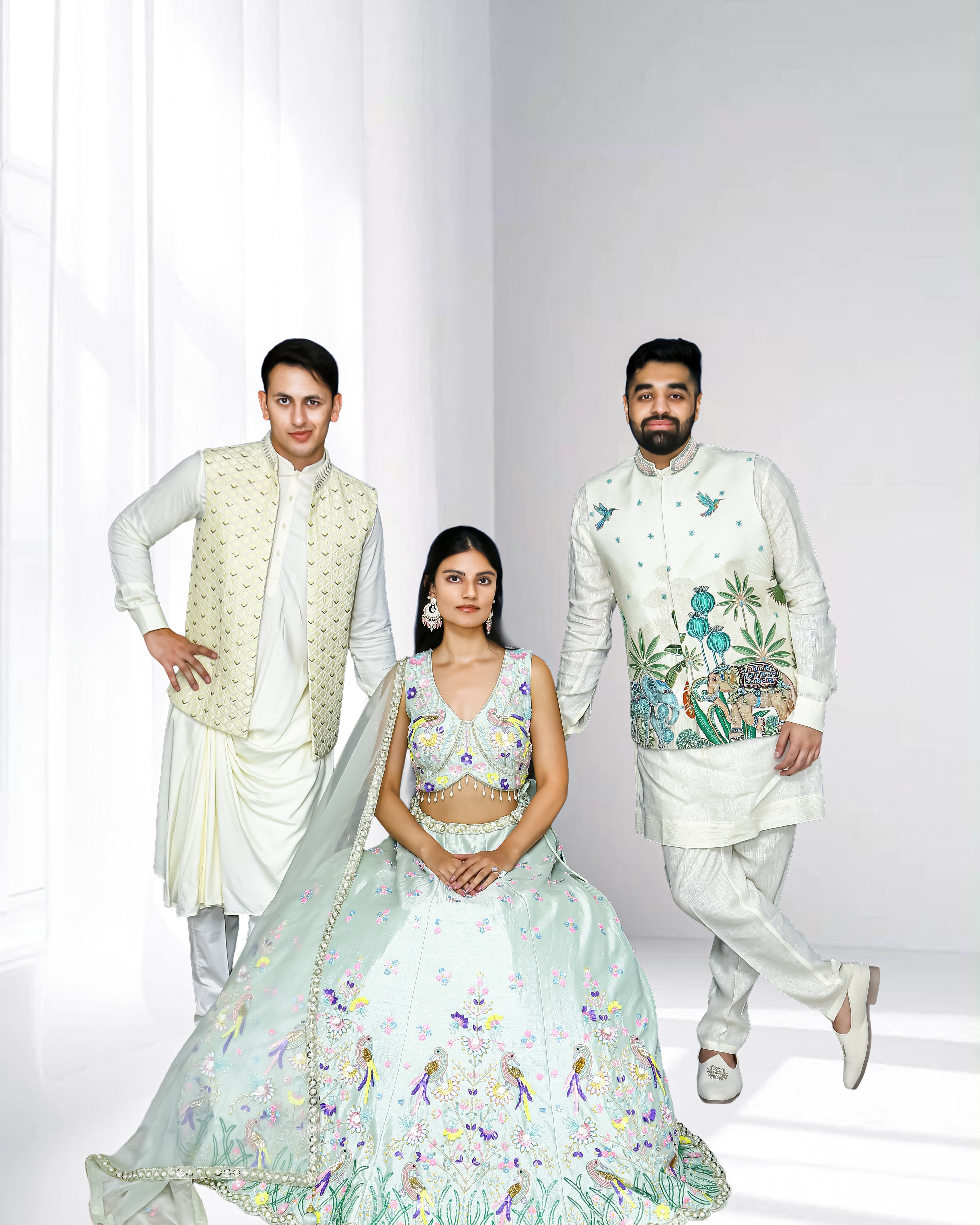 Pastel ethnic wear collection featuring a woman in a mint embroidered lehenga and two men in ivory sherwanis with embroidered details, styled for weddings and festive occasions