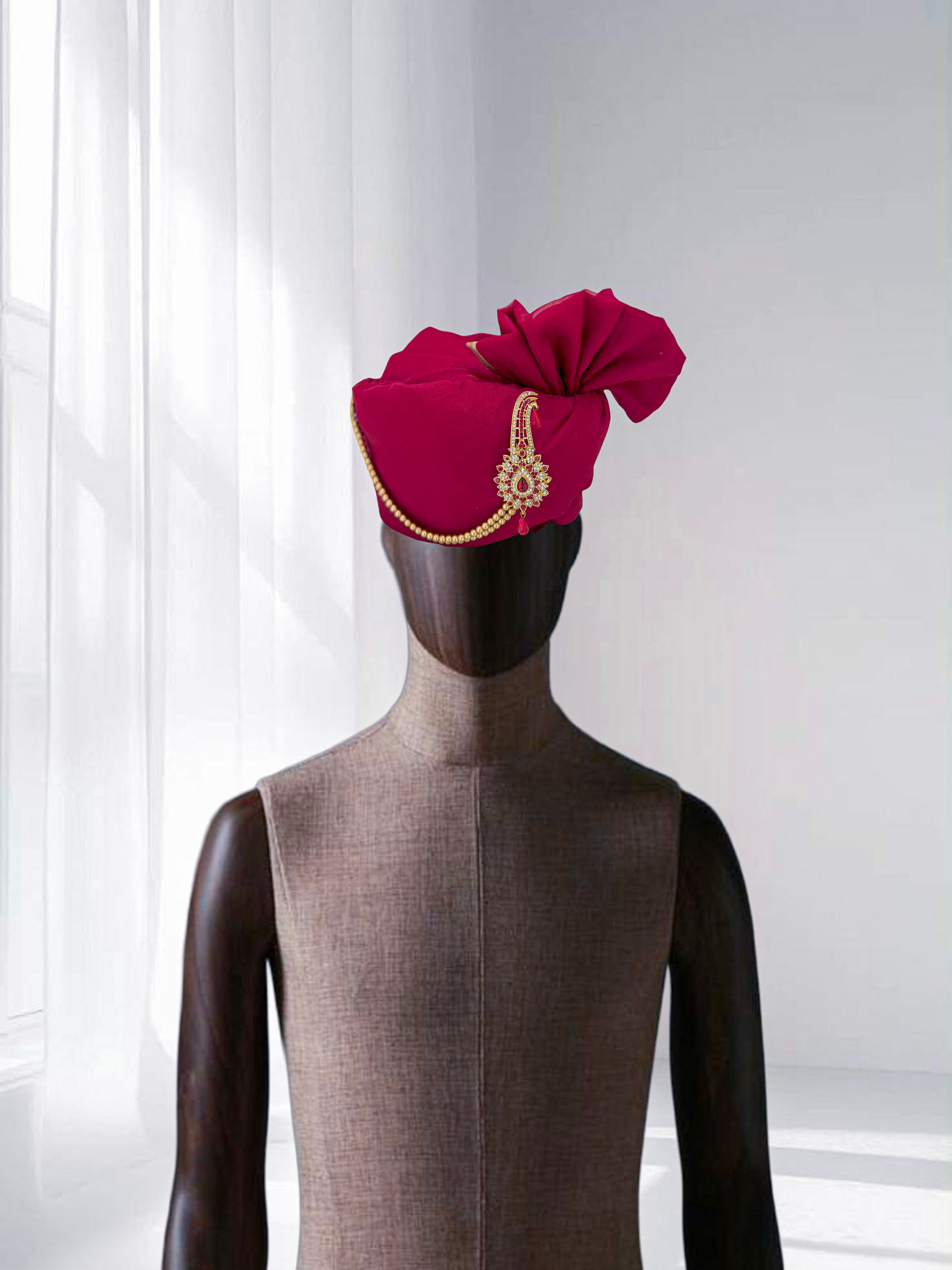Elegant rani pink wedding safa with gold border detailing, groom’s traditional turban.