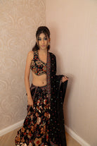 Black floral embroidered lehenga set with sculpted blouse and sheer dupatta with border and tassels.