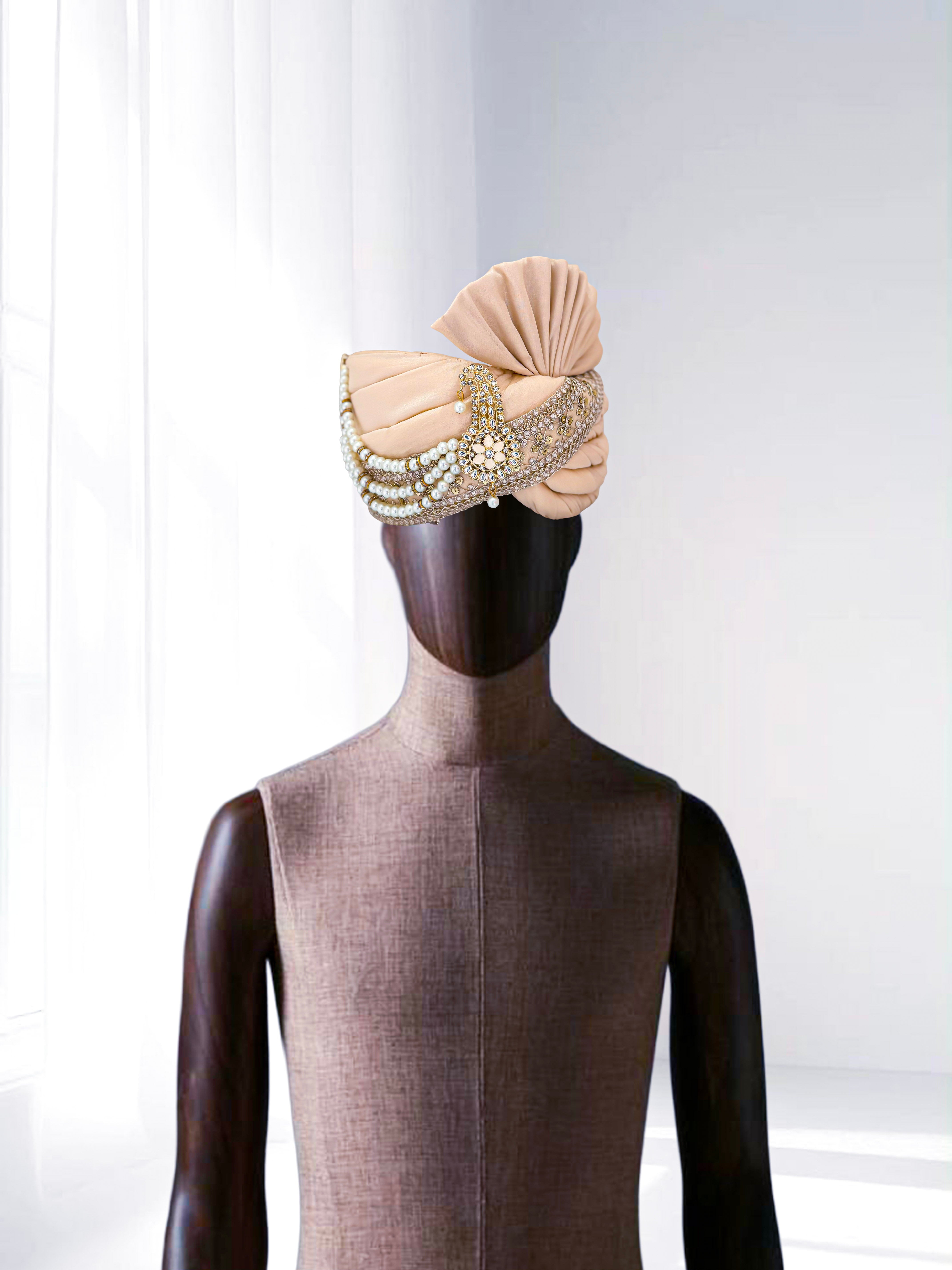Beige groom safa turban with pearl chains and golden embroidery, perfect for weddings.