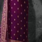 Unstitched plum purple georgette suit with gold zari embroidery and matching embroidered dupatta.