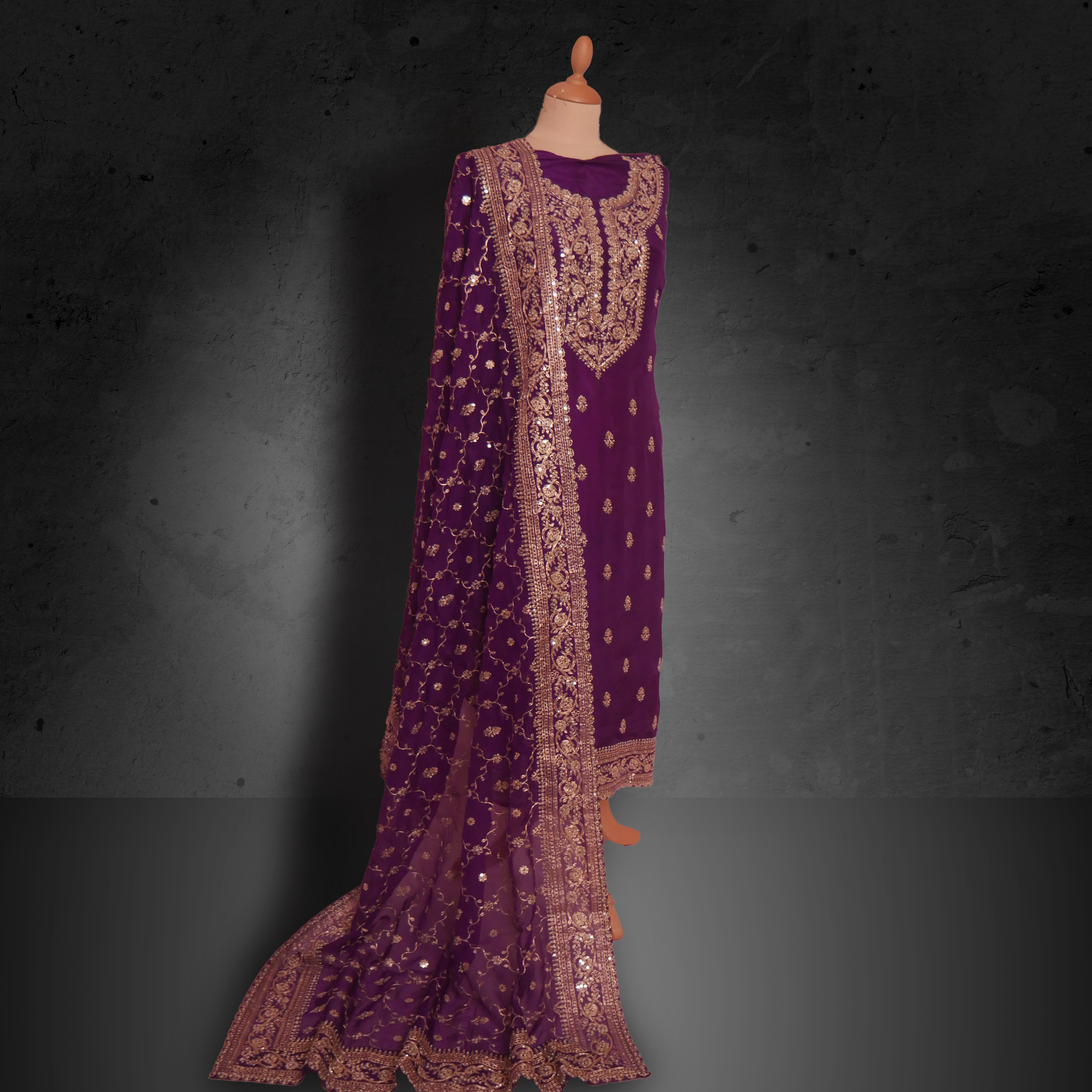Unstitched plum purple georgette suit with gold zari embroidery and matching embroidered dupatta.
