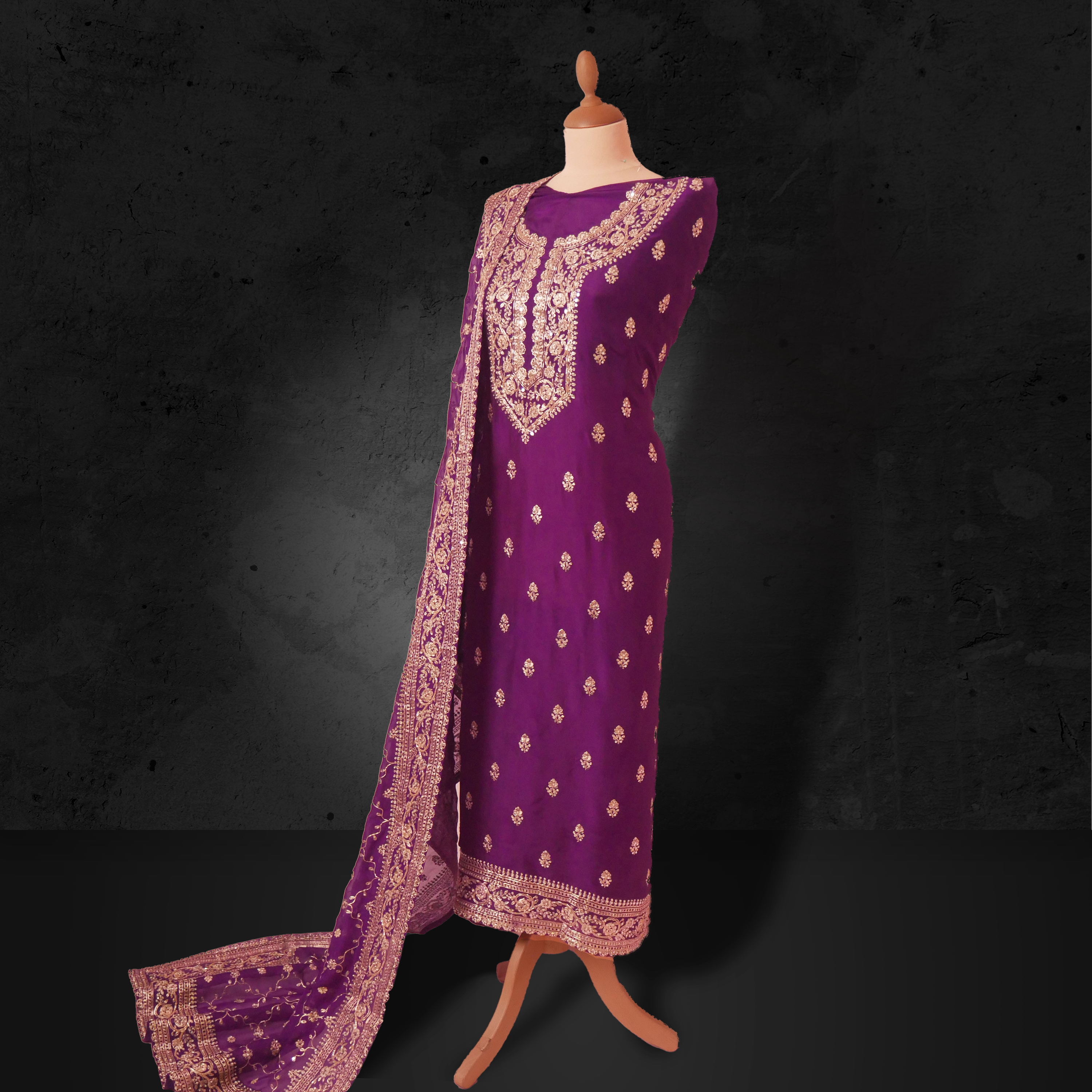 Unstitched plum purple georgette suit with gold zari embroidery and matching embroidered dupatta.