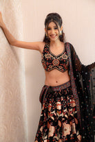 Black floral embroidered lehenga set with sculpted blouse and sheer dupatta with border and tassels.